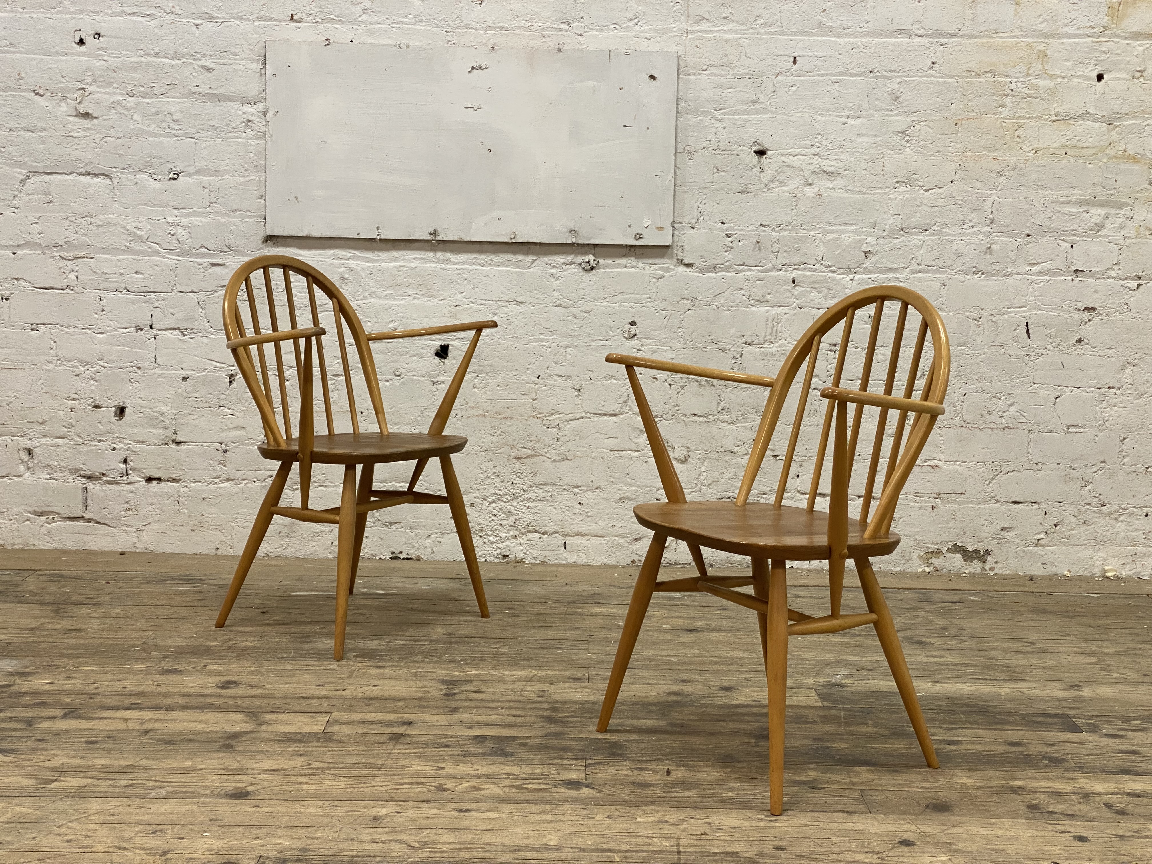 Ercol, a pair of elm and beech Windsor type carver dining chairs, with hoop and spindle back above