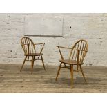 Ercol, a pair of elm and beech Windsor type carver dining chairs, with hoop and spindle back above