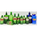 A group of coloured glass apothecary/chemist jars comprising ten green glass jars (mostly fluted