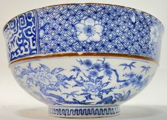 A Japanese blue and white porcelain bowl, the exterior decorated with Chinese style prunus blossom