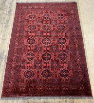 A hand knotted Afghan Bokhara rug, typically designed, and bordered. 304cm x 205cm.