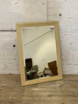 A contemporary wall hanging mirror with bevelled plate. 102cm x 74cm.