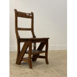 A Victorian style hardwood metamorphic chair, folding over to form a three rung library step ladder.