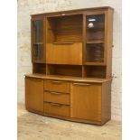 A mid century teak two part high board, the illuminated top section fitted with two glazed doors,