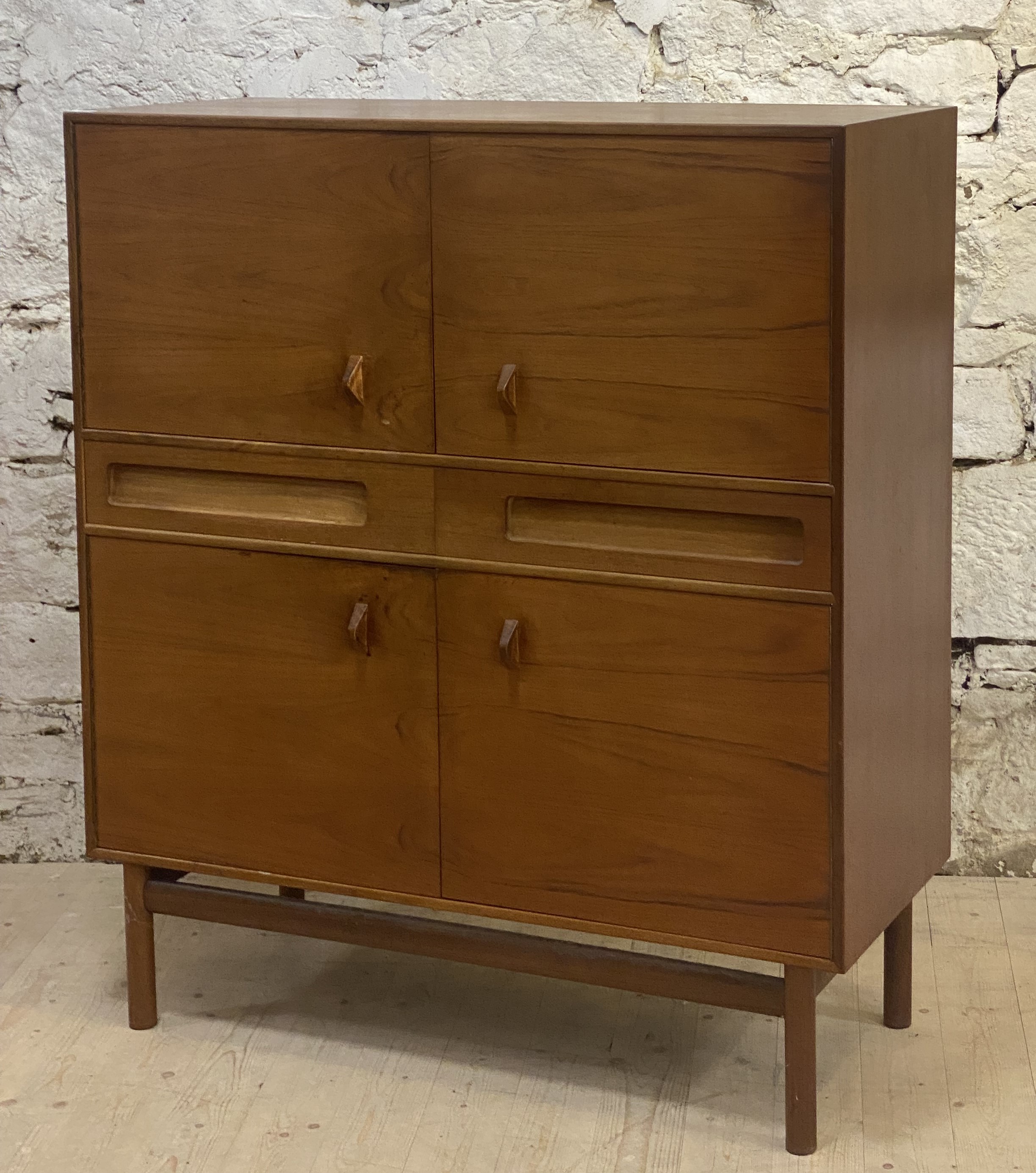 McIntosh of Kirkcaldy, A mid century teak high board, circa 1960's, fitted with four cupboards,