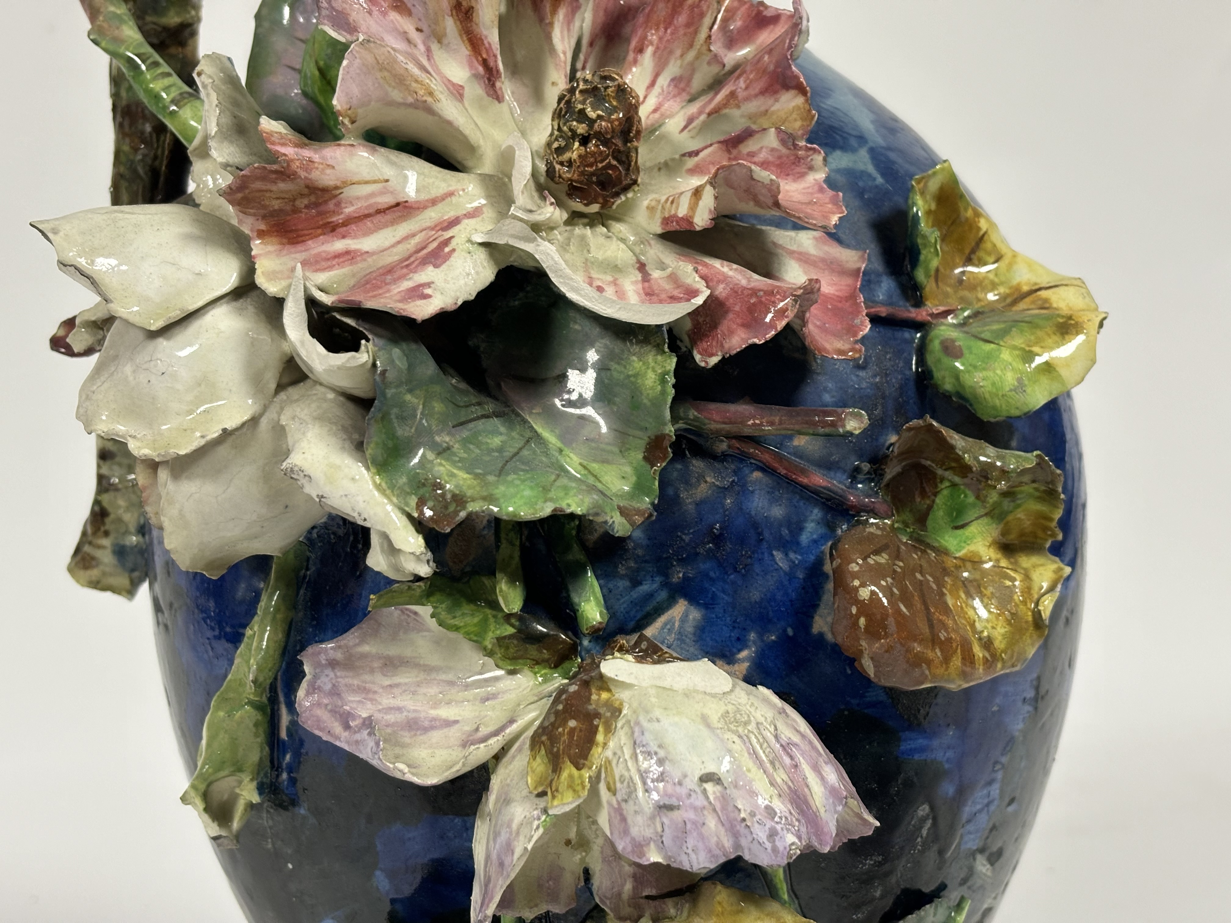 A large hand-painted in the style of French barbotine majolica pottery jug vase with floral - Image 3 of 3