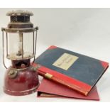 A vintage enamelled lantern/Tilley lamp (h- 35cm), together with an early twentieth century ledger