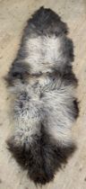 A 'Hide rugs' sheep skin rug. L210cm.