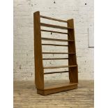 Ercol, an elm open bookcase shelf, with two fixed and two adjustable shelves on tapered panel end