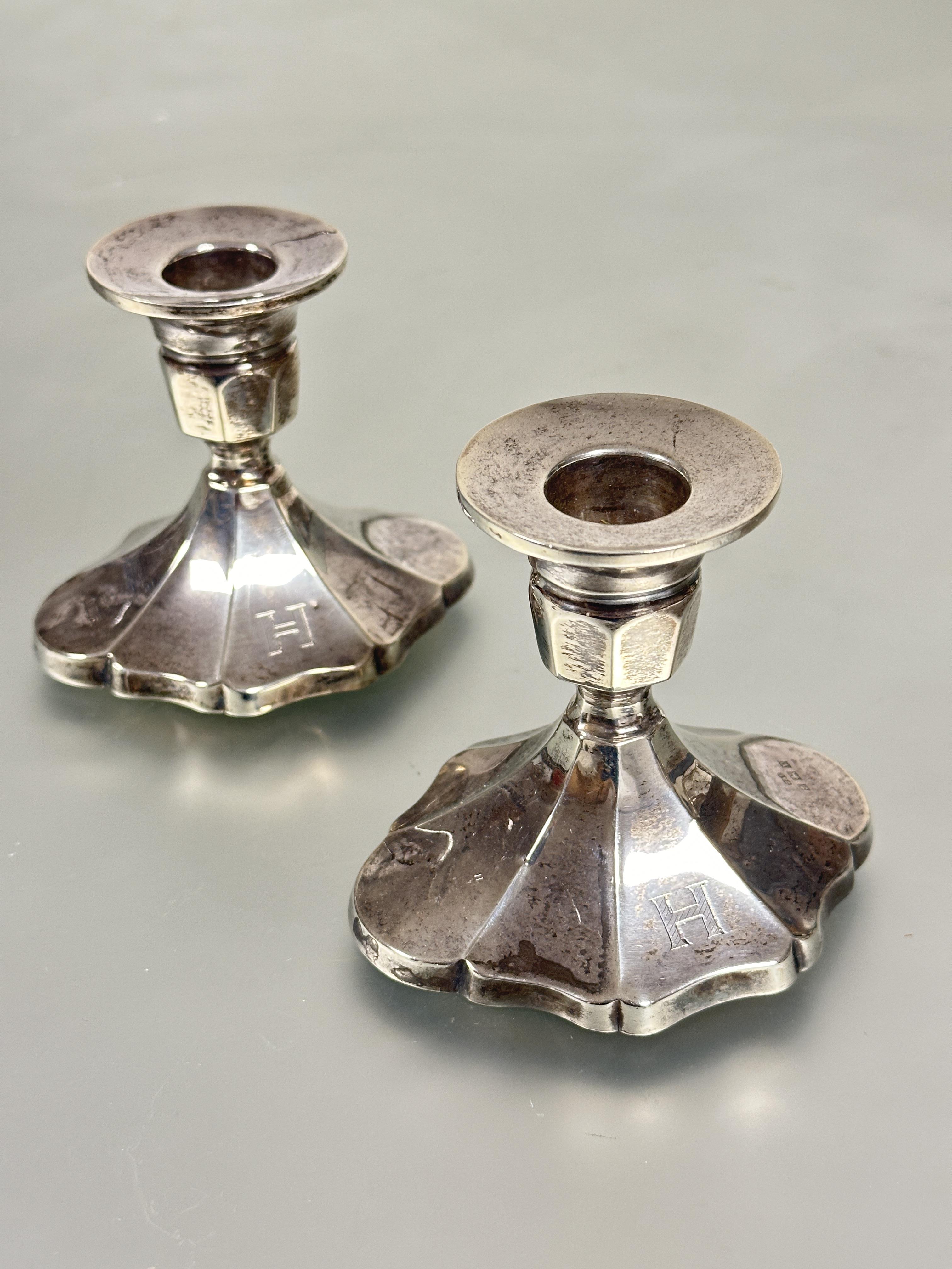 A pair of Birmingham silver short table candle sticks with octagonal tops raised on quatrefoil style