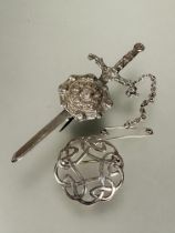 A silver claymore and shield brooch with safety chain L x 8.5cm and a silver circular knot style