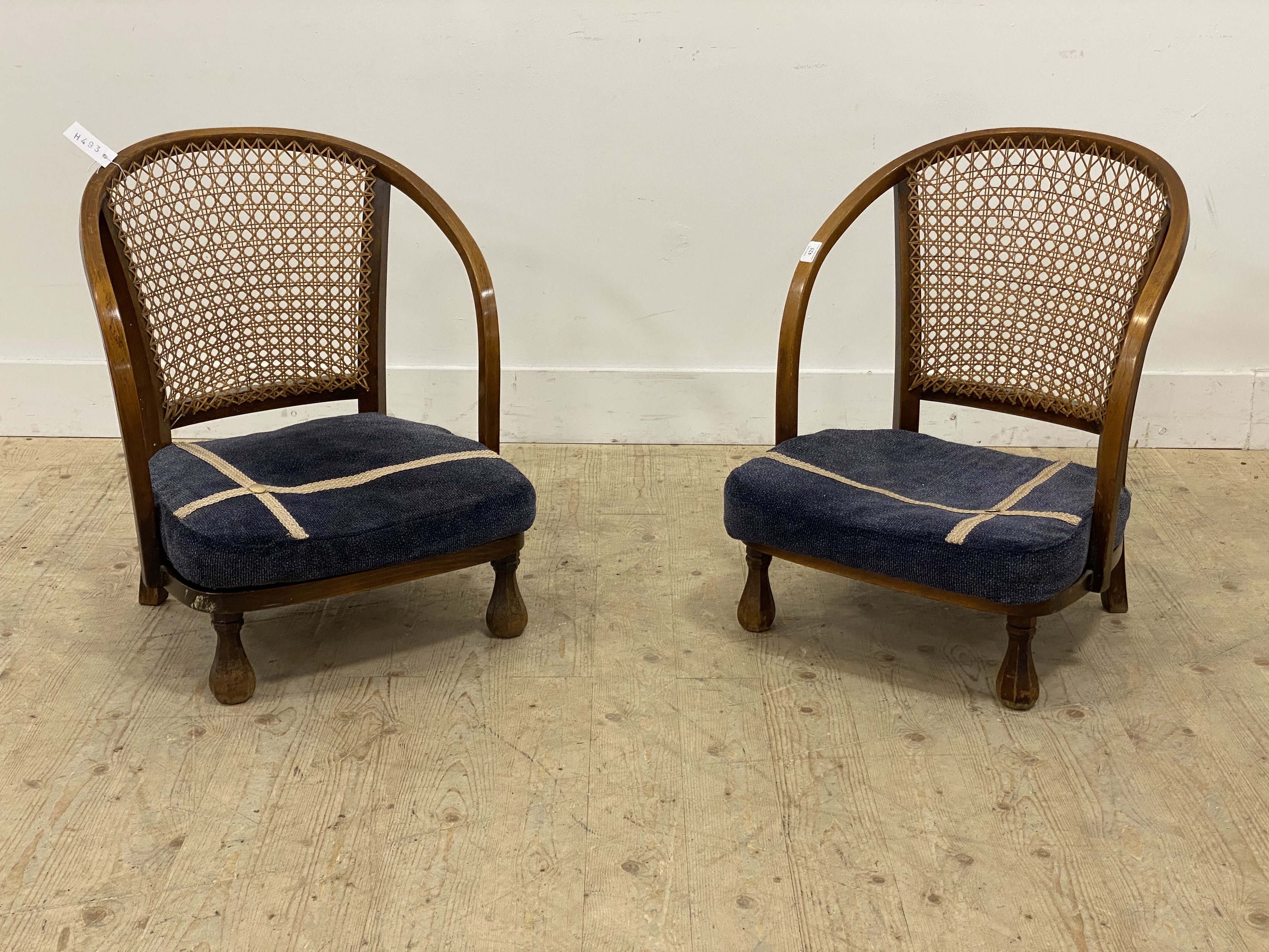 A pair of 1930's bentwood and cane bedroom chairs, with upholstered seat cushions and faceted
