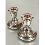 A pair of Birmingham silver desk candle sticks raised on circular weighted baize covered bases