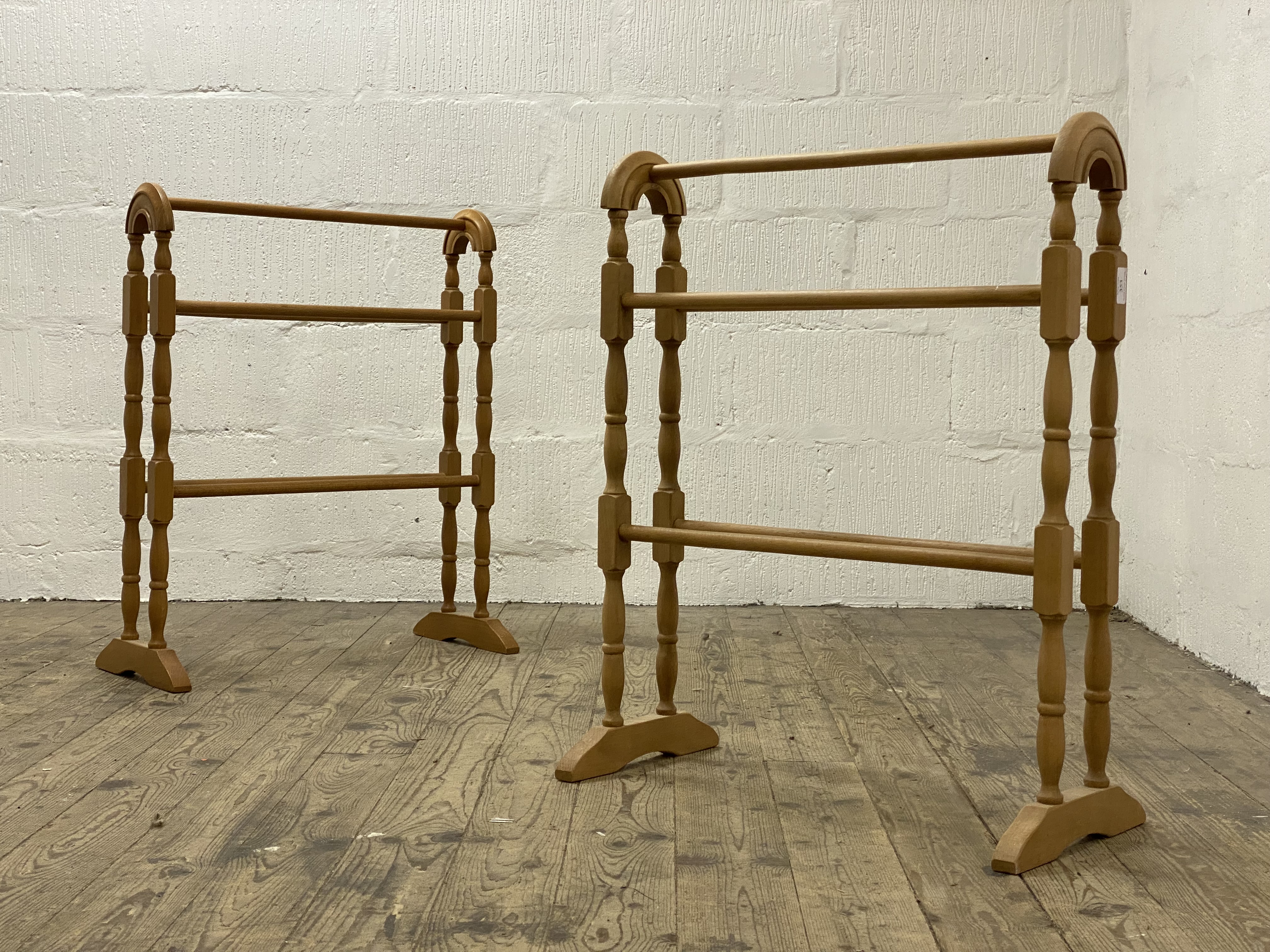 A  pair of early 20th century turned beech towel rails H78cm, L63cm.