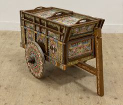 A 20th century drinks trolley of cart form, with brightly painted decoration. H63cm, L104cm.