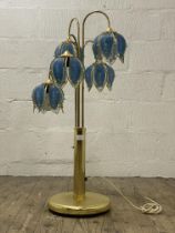 A Vintage brass floor lamp, four branches with coloured glass shades formed as lotus flowers.