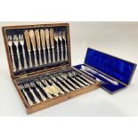 An Edwardian oak cased Walker and Hall canteen of silver plated cutlery comprising twelve forks, amd