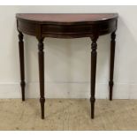 A Georgian style demi-lune mahogany console table, the tooled red leather top above a drawer and