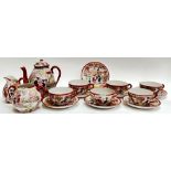 A Japanese Kutani style tea set decorated with enamelled figural scenes against a white and iron red