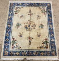 A Chinese washed wool carpet, thick pile, the beige field and border decorated with auspicious