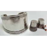 A pair of middle Eastern/Indian white metal thimbles with filigree decoration and coral elements,