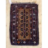 A hand knotted Baluch Ballisht bag face rug, the brown field with geometric floral design and having