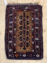 A hand knotted Baluch Ballisht bag face rug, the brown field with geometric floral design and having