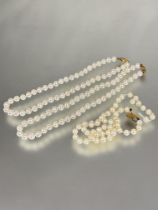 A pair of matched cultured pearl choker necklaces with 9ct gold oval clasp fastenings L x 16cm and a