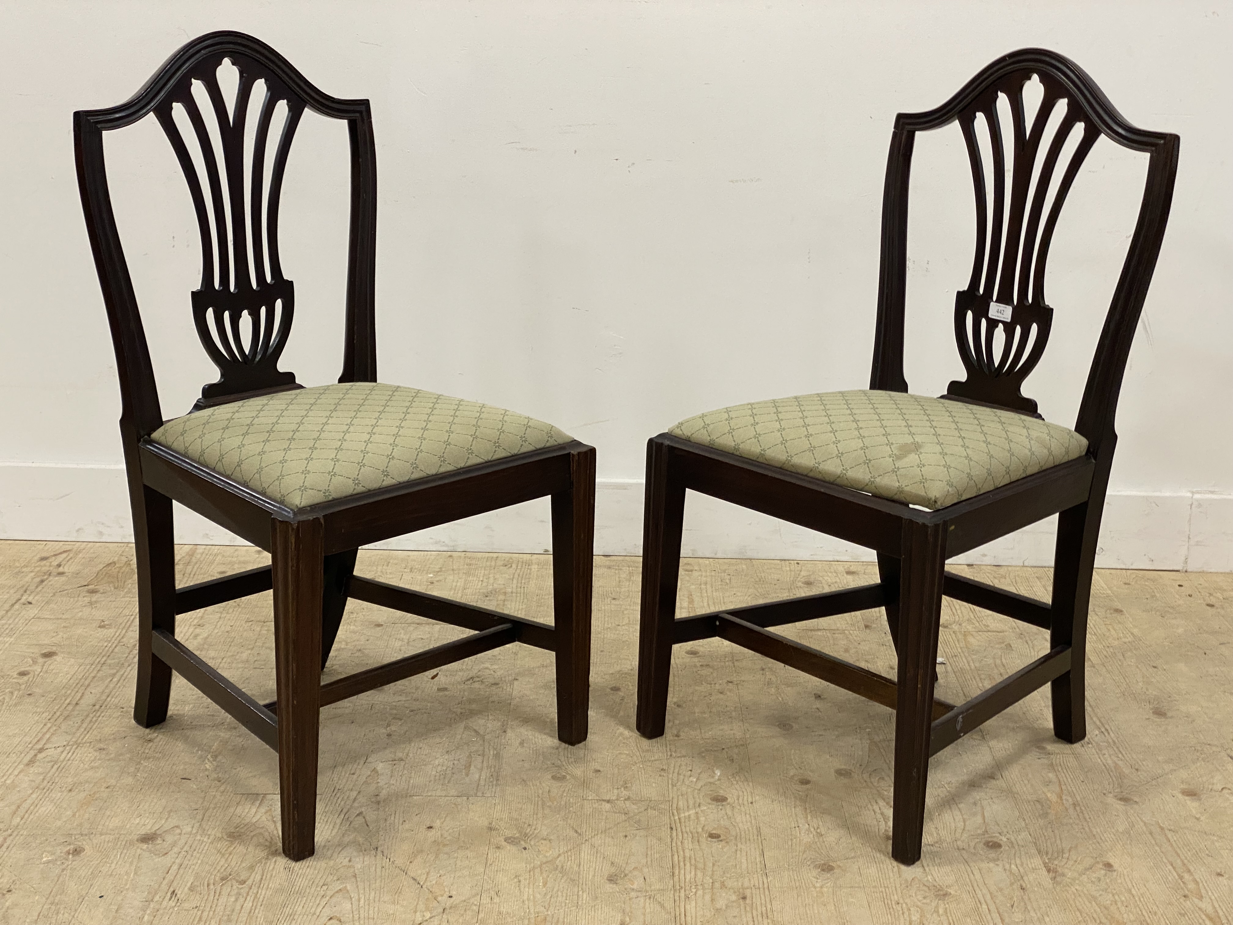 A pair of 19th century mahogany side chairs, with pierced splat backs above drop in seat pads,