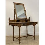 An Aesthetic period ash dressing table, the swing mirror above a trinket drawer and long drawer,