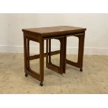 McIntosh, a mid century teak metamorphic nest of three tables, with fold over revolving top and