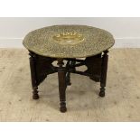 A late 19th century occasional table, the brass tray top with centre well and chased floral