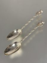 A pair of Edwardian cast London Silver thistle terminal tea spoons with engraved naturalistic