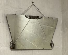 An Art Deco period wall mirror of geometric outline, with white metal mounts. 141cm x 69cm.