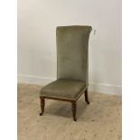 A Victorian walnut bedroom chair, the high back and seat upholstered in green velvet, raised on