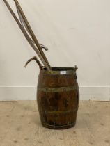 A 19th century cooped oak stick stand of barrel form, with brass swing handle (H51cm) together