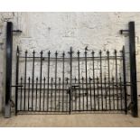 A pair of wrought iron driveway gates, and complete with later box section posts. Overall width