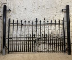 A pair of wrought iron driveway gates, and complete with later box section posts. Overall width