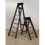 A Vintage pine seven rung folding step ladder (H174cm) together with a smaller set. (2)