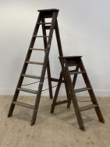 A Vintage pine seven rung folding step ladder (H174cm) together with a smaller set. (2)