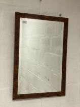 A burr walnut framed wall hanging mirror with bevelled glass. 50cm x 73cm.