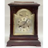An early 20th century German bracket clock, the mahogany case with gadrooned caddy top above a