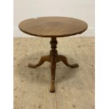 A 19th century mahogany tripod table, the circular top raised on a turned column with triple splay