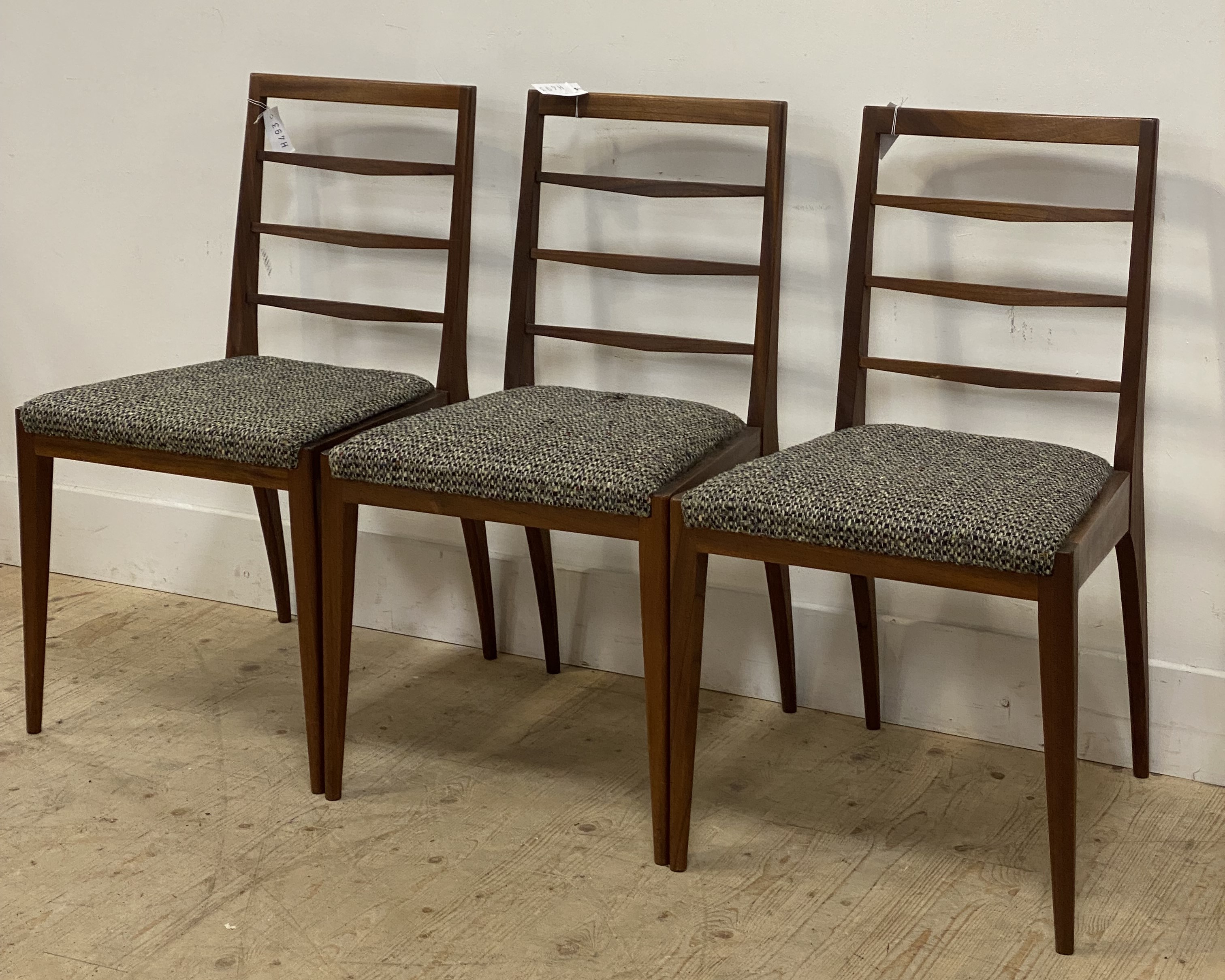 McIntosh, a set of three mid century teak dining chairs, with ladder backs, upholstered seat pads