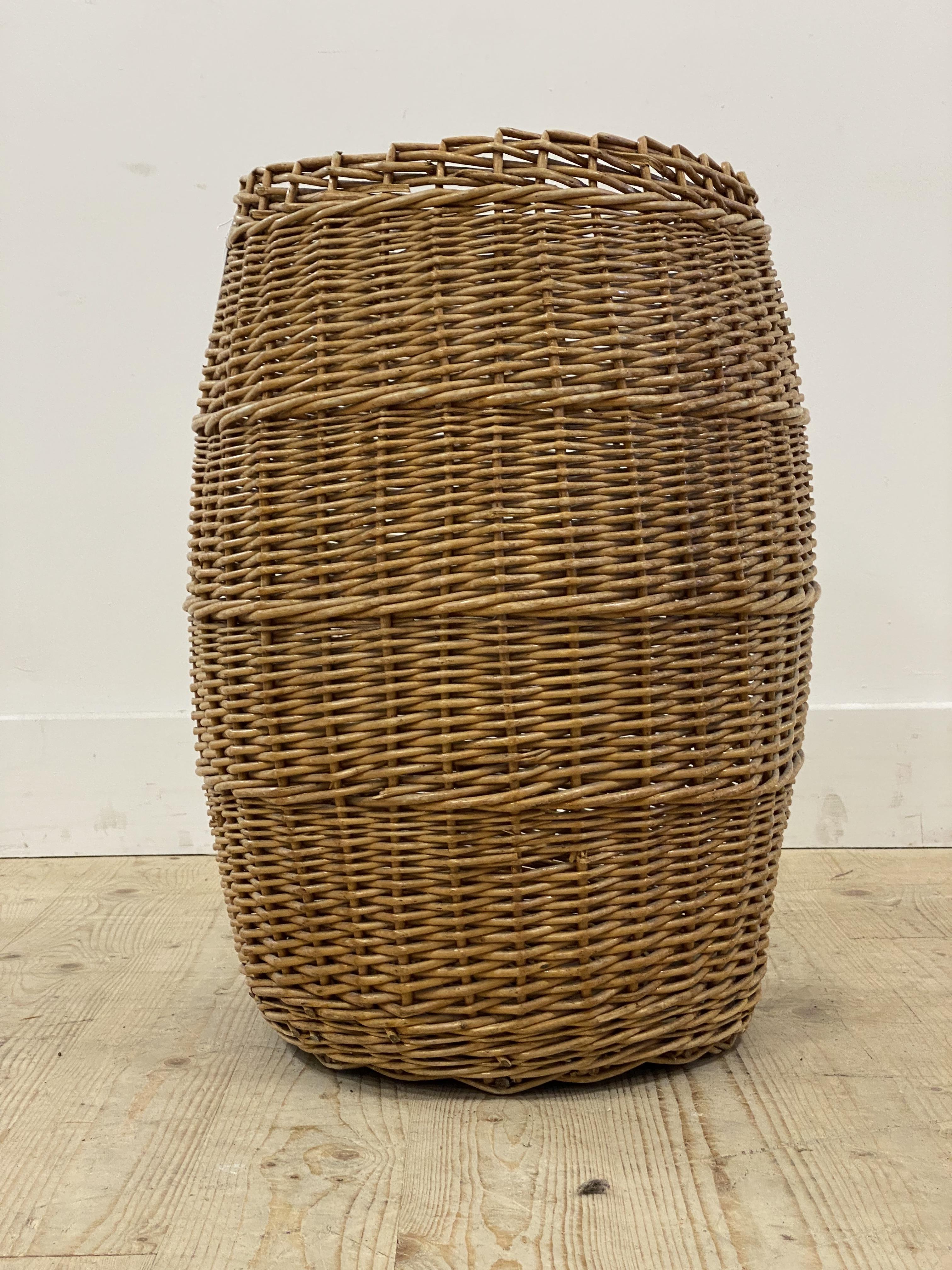 A vintage wicker laundry basket of compressed cylindrical form. H59cm.