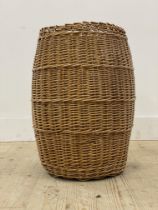 A vintage wicker laundry basket of compressed cylindrical form. H59cm.
