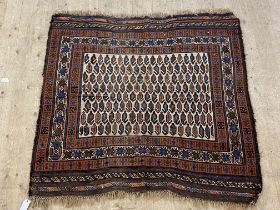 An antique Baluch Soumak rug, the ivory field with boteh motif within a multi-line border. 135cm x