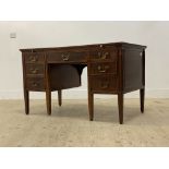 An Edwardian mahogany writing desk, the top inset with tooled blue leather writing surface, above