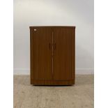 A mid century teak bow front cocktail cabinet / drinks bar, the top with fold over top to each side,