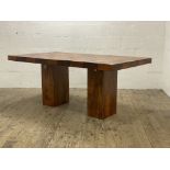 An Indonesian hardwood dining table, the rectangular top raised on two on two oblong pedestals.